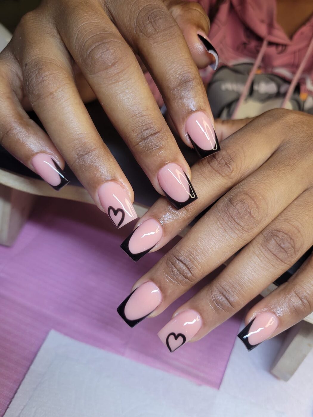 Medium length acrylic extensions with black French tip and heart art